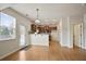 Open kitchen features hardwood floors, stainless appliances, breakfast bar, and lots of natural light at 203 Creek View Ln, Acworth, GA 30102