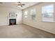 Bright living room with a fireplace, neutral walls and carpet, and lots of natural light from large windows at 203 Creek View Ln, Acworth, GA 30102