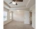 This carpeted main bedroom features recessed ceiling detail and abundant natural light from multiple windows at 203 Creek View Ln, Acworth, GA 30102