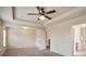 Spacious carpeted main bedroom with ceiling fan and natural light from a window at 203 Creek View Ln, Acworth, GA 30102