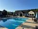 Community pool with lounge chairs, umbrellas, and clear blue water for relaxing in the sun at 203 Creek View Ln, Acworth, GA 30102