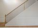 Classic staircase with hardwood and iron railing, featuring wainscoting and hardwood floors at 203 Creek View Ln, Acworth, GA 30102