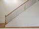 Elegant staircase with wooden treads and black iron railing, complemented by classic wall paneling at 203 Creek View Ln, Acworth, GA 30102