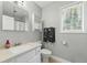 Bathroom featuring a vanity with sink, framed mirror, and a cabinet for storage at 4773 Aberdeen Ln, Stone Mountain, GA 30083