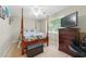 Bedroom featuring carpet, bed, dresser, tv and a window at 4773 Aberdeen Ln, Stone Mountain, GA 30083
