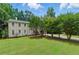 Charming two-story home featuring a well-manicured lawn, mature trees, and a welcoming entrance at 4773 Aberdeen Ln, Stone Mountain, GA 30083