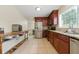 Bright kitchen with stainless steel appliances, wooden cabinets, tile flooring and a spacious layout at 4773 Aberdeen Ln, Stone Mountain, GA 30083