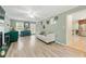 Open-concept living room with modern decor, wood floors, and view into the kitchen at 4773 Aberdeen Ln, Stone Mountain, GA 30083