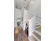 Bright and airy foyer with tall ceilings, wood floors, and a staircase leading to the second floor at 11684 Stovall Pl, Hampton, GA 30228