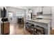 Bright kitchen features stainless steel appliances, a granite countertop island, and modern cabinetry at 11684 Stovall Pl, Hampton, GA 30228