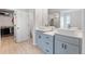 A bathroom featuring double sink, a linen closet, and a shower/tub combo with neutral walls at 11684 Stovall Place Pl, Hampton, GA 30228