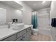 A clean bathroom featuring a single sink vanity, shower/tub combo and neutral walls at 11684 Stovall Place Pl, Hampton, GA 30228