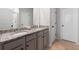 Bathroom features granite countertops, double sinks, chrome fixtures, and tile floors at 11684 Stovall Place Pl, Hampton, GA 30228