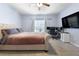 Spacious bedroom with plush carpeting, a ceiling fan, a queen bed and home office at 11684 Stovall Place Pl, Hampton, GA 30228
