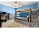 A bedroom with light blue walls, bunk beds, desk, dresser and neutral carpet at 11684 Stovall Place Pl, Hampton, GA 30228