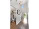 Welcoming entryway with hardwood floors, high ceilings, a decorative clock, and a view of the staircase at 11684 Stovall Place Pl, Hampton, GA 30228