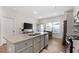 Kitchen with granite counters, stainless appliances, breakfast bar, and hardwood floors at 11684 Stovall Place Pl, Hampton, GA 30228