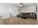 Comfortable living room with wood floors and a spacious sectional sofa, perfect for relaxation at 11684 Stovall Place Pl, Hampton, GA 30228