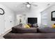 Living room with laminate flooring, ceiling fan, TV, and a comfortable sectional sofa at 11684 Stovall Place Pl, Hampton, GA 30228