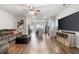 Open-concept living area with hardwood floors, neutral tones, and seamless flow to the kitchen at 11684 Stovall Place Pl, Hampton, GA 30228