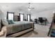 This main bedroom features tray ceilings, soft carpet, and multiple sunny windows at 11684 Stovall Place Pl, Hampton, GA 30228