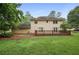 Well-maintained backyard with lush green grass, mature trees, and a wooden deck, perfect for outdoor enjoyment at 1338 Nonie Way, Marietta, GA 30062