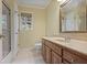 Bathroom featuring a vanity with wood cabinets, a shower with glass doors, and white hexagon tile flooring at 1338 Nonie Way, Marietta, GA 30062