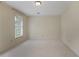 A simple bedroom with ample carpeted space and a large window bringing in natural light at 1338 Nonie Way, Marietta, GA 30062