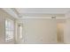 Bedroom featuring white walls, crown molding, and two doors leading to other rooms at 1338 Nonie Way, Marietta, GA 30062