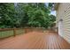Wood deck showcasing outdoor living with a stained railing, bordering the large yard and home's exterior at 1338 Nonie Way, Marietta, GA 30062