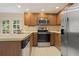 Traditional kitchen with stainless steel appliances, ample cabinets, and views to the deck at 1338 Nonie Way, Marietta, GA 30062