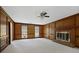 Spacious carpeted living room with wood paneled walls and cozy brick fireplace at 1338 Nonie Way, Marietta, GA 30062