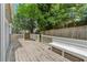 Wooden back deck featuring a wooden bench and white railing, and a sliding glass door, with mature trees at 3015 Cranbrook Nw Walk, Kennesaw, GA 30144