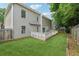 The backyard features a well-maintained lawn, a wooden fence, and a relaxing deck for outdoor enjoyment at 3015 Cranbrook Nw Walk, Kennesaw, GA 30144