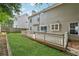 Large deck overlooking the grassy backyard with a privacy fence and a two-story home with light siding at 3015 Cranbrook Nw Walk, Kennesaw, GA 30144