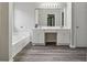 Bright primary bathroom with dual vanity, soaking tub and wood look flooring at 3015 Cranbrook Nw Walk, Kennesaw, GA 30144