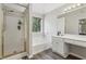 Bathroom featuring a glass enclosed shower, a soaking tub, dual sinks, and a large window at 3015 Cranbrook Nw Walk, Kennesaw, GA 30144