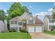 Charming two-story home with a well-manicured lawn, complemented by a stone accent wall and a two-car garage at 3015 Cranbrook Nw Walk, Kennesaw, GA 30144