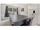 This game room features a multi-use table, wall paneling, neutral paint, and access to the dining room at 3015 Cranbrook Nw Walk, Kennesaw, GA 30144