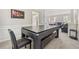 Versatile game room space with a pool table doubling as a dining table and a cozy seating area beyond at 3015 Cranbrook Nw Walk, Kennesaw, GA 30144
