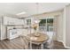 Eat-in kitchen features white cabinetry, granite countertops, stainless steel appliances, and deck access at 3015 Cranbrook Nw Walk, Kennesaw, GA 30144