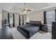 Bright main bedroom with grey carpet, ceiling fan, and ensuite bathroom at 3015 Cranbrook Nw Walk, Kennesaw, GA 30144
