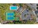 Aerial view showcasing community amenities with a swimming pool, tennis courts, playground, and parking area at 307 Cabinwood Trl, Canton, GA 30115