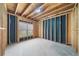 Unfinished basement with wooden framing, concrete floor, window, and ceiling lighting, ready for customization at 307 Cabinwood Trl, Canton, GA 30115