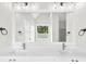 Double vanity bathroom with granite countertop, modern lighting, and decorative accents at 307 Cabinwood Trl, Canton, GA 30115
