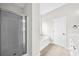 Bathroom featuring glass shower, soaking tub, and a door to the toilet area at 307 Cabinwood Trl, Canton, GA 30115