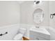 Powder room features a vanity with a stylish mirror, light fixture, and modern commode at 307 Cabinwood Trl, Canton, GA 30115