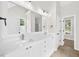 Bathroom features white cabinets, double sinks, and large mirror with modern lighting at 307 Cabinwood Trl, Canton, GA 30115