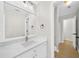 Bright bathroom with white cabinets, updated fixtures, and a large mirror at 307 Cabinwood Trl, Canton, GA 30115