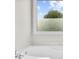 A close up of a soaking tub featuring brushed nickel hardware and frosted windows for privacy at 307 Cabinwood Trl, Canton, GA 30115
